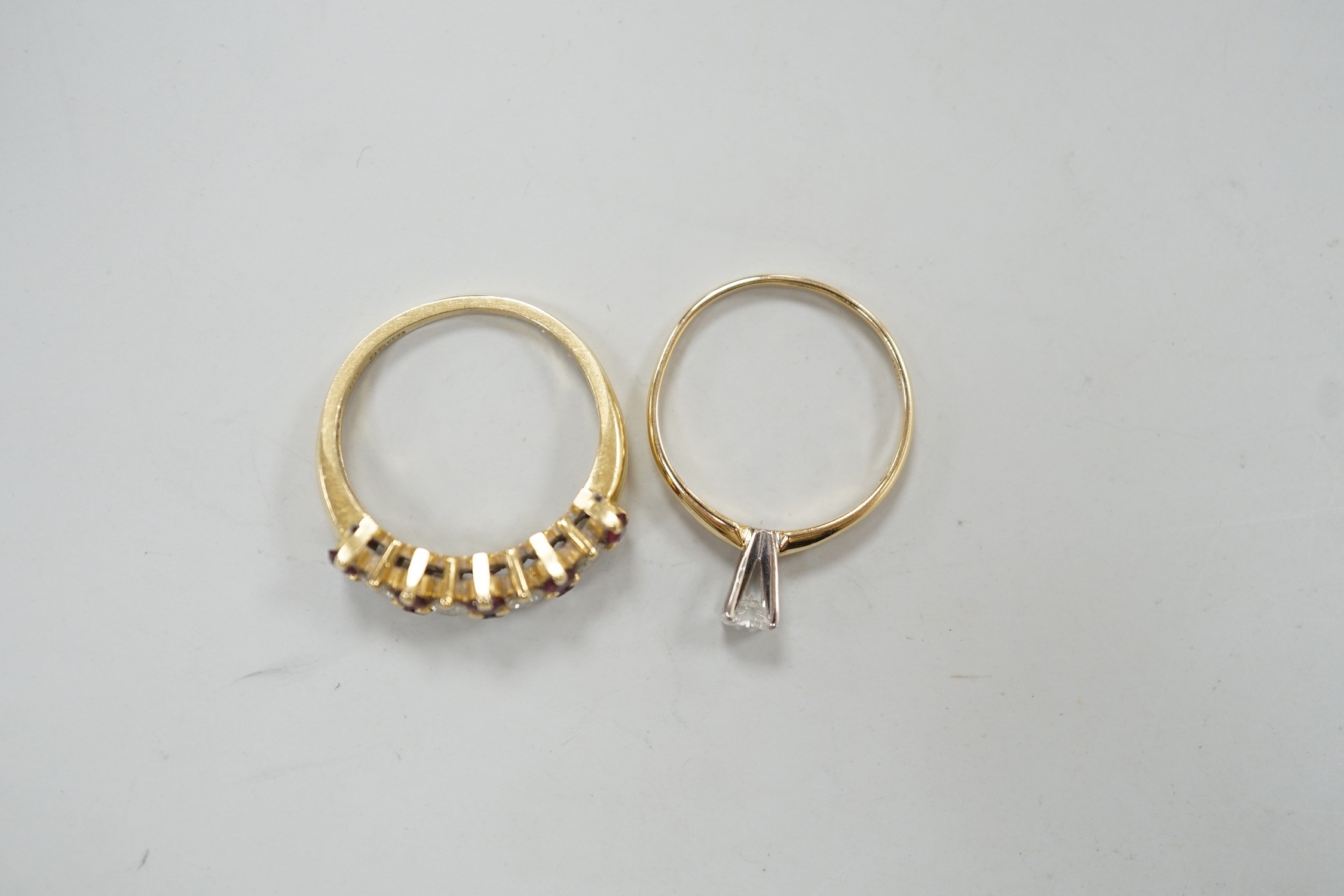 A modern 18ct gold, ruby and diamond cluster set half hoop ring, size L, gross weight 3.4 grams and a 14k and solitaire diamond set ring, size L, gross weight 1.1 grams.
